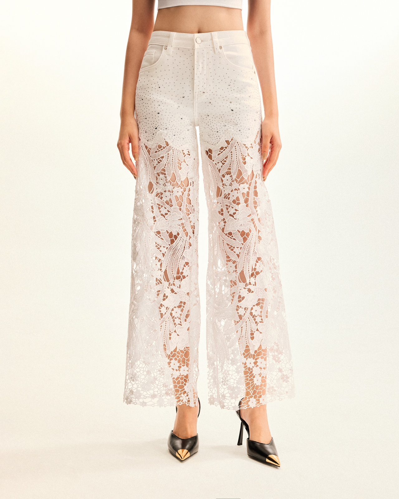 Jeans in denim bianco a vita alta con gamba ampia, ricami in pizzo e strass